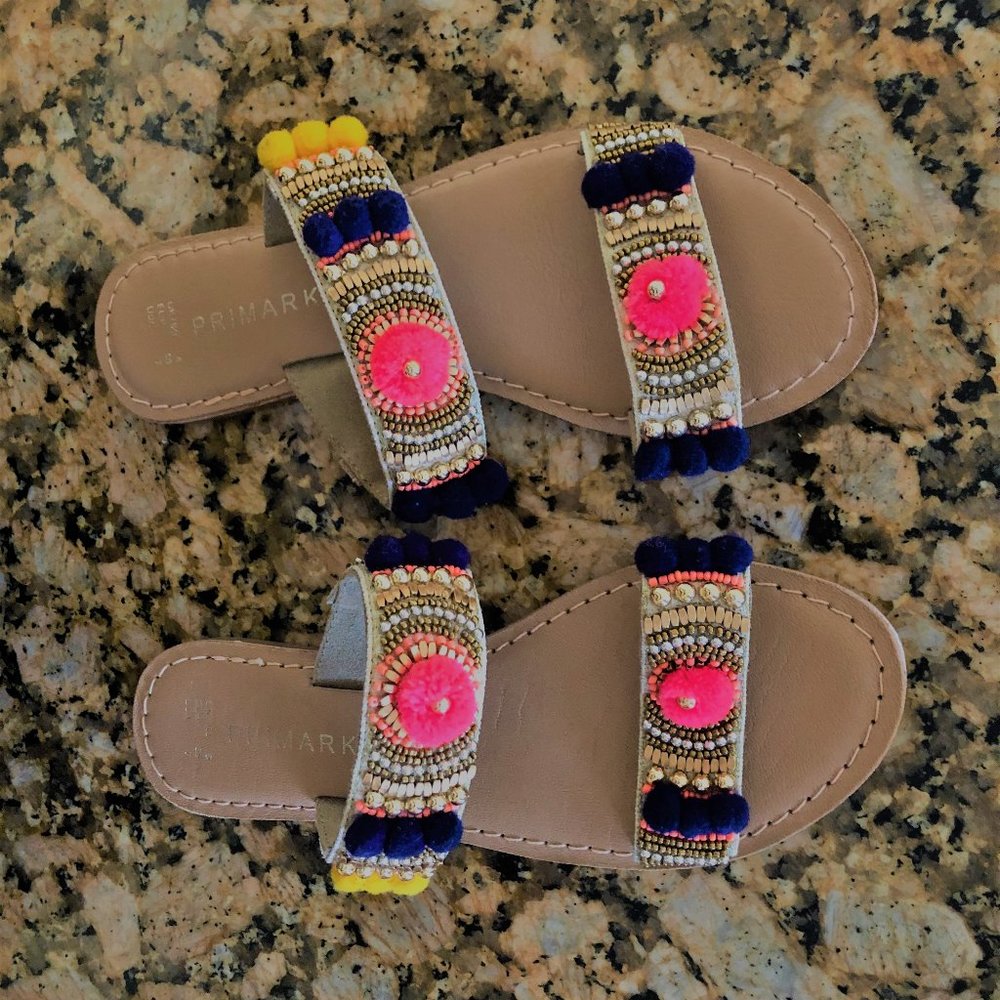 Leather beaded slippers with pom-poms